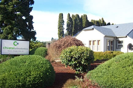 Chvatal Orthodontics office exterior with manicured landscaping and white building entrance.