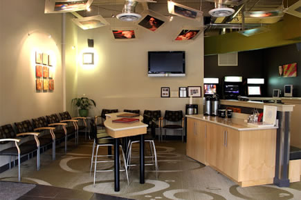 Modern orthodontic office waiting room with seating area, reception desk, and contemporary decor.